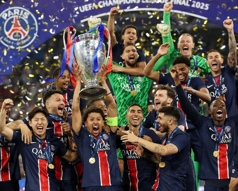 Paris Saint-Germain players lift the UEFA Champions League trophy